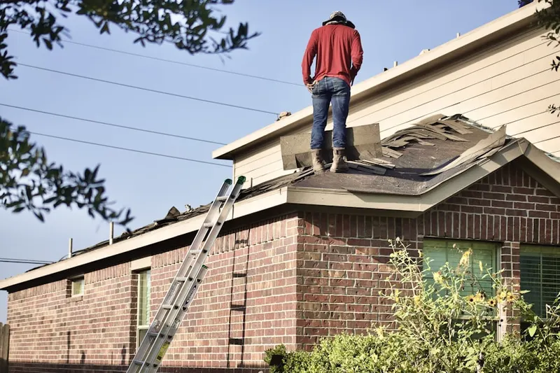Professional roofer working on a residential roof in Cascades